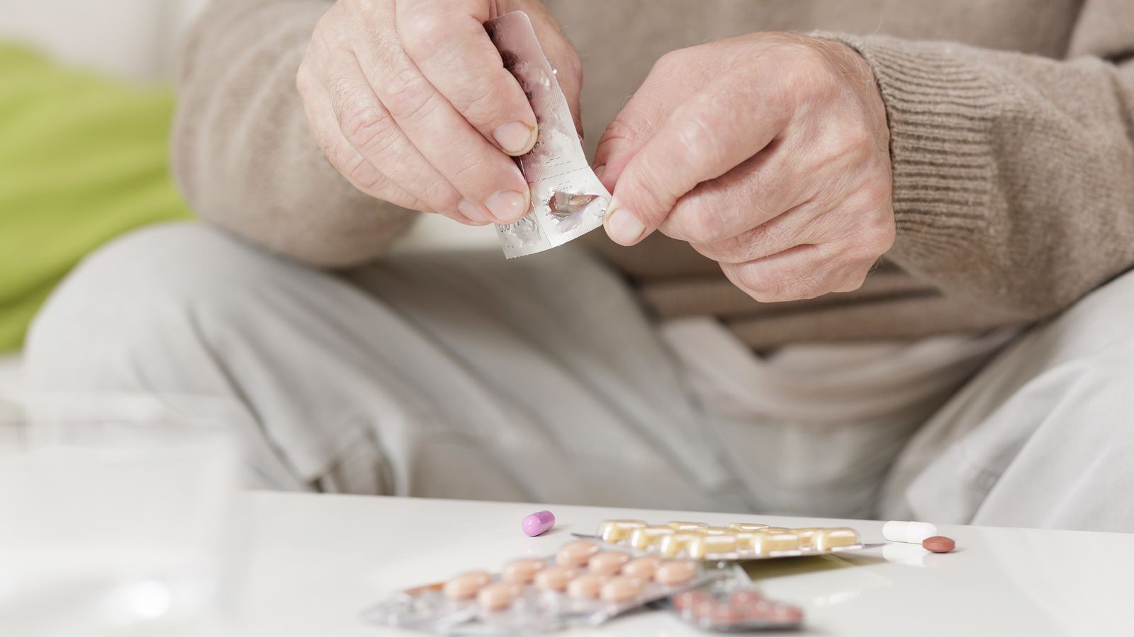 Senior nimmt Tabletten aus der Verpackung