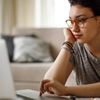 Young woman is sitting in front of a laptop