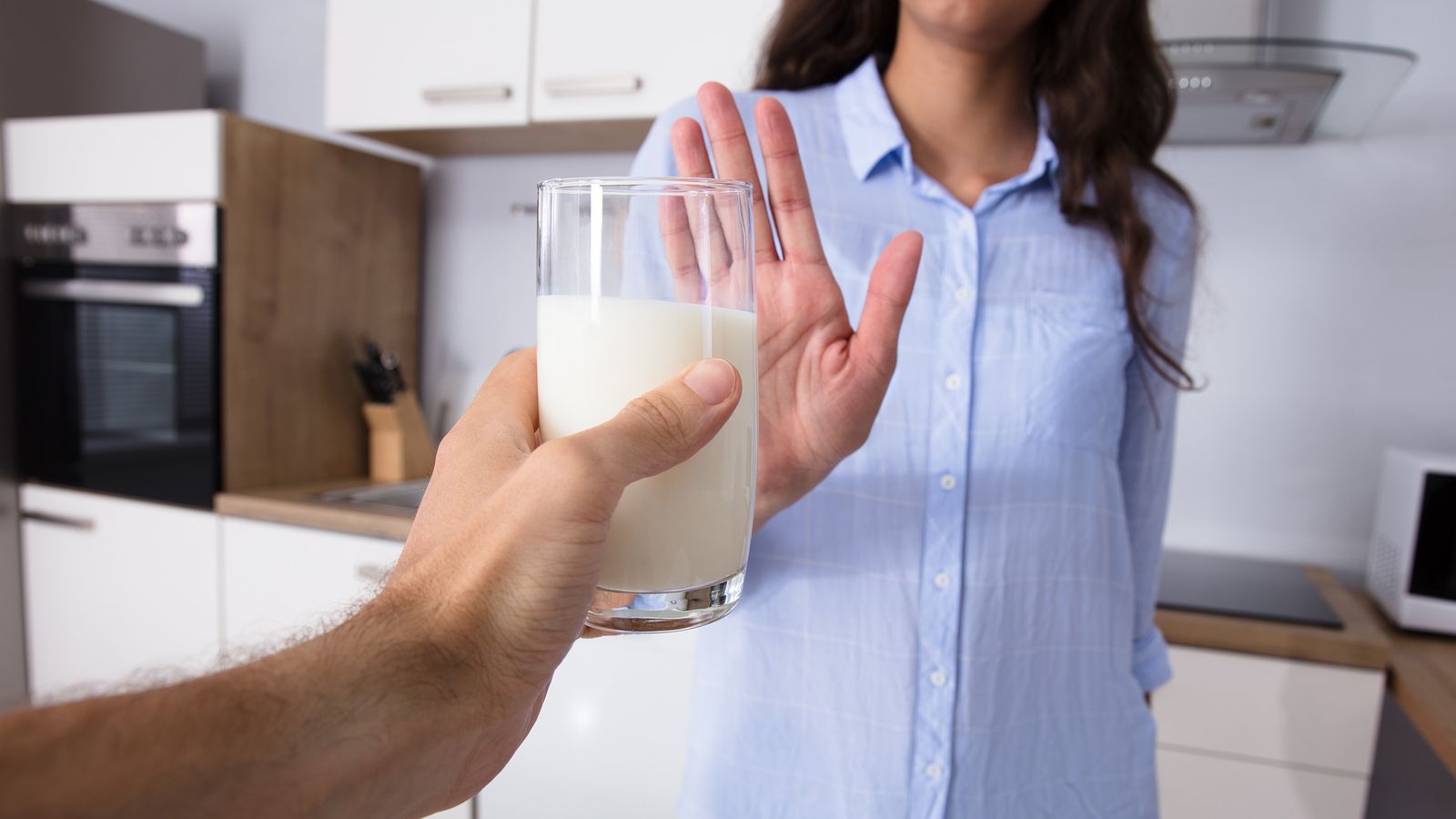 Frau mit Akne lehnt es ab ein Glas Milch zu trinken