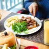 Teller mit Essen und Glas Orangensaft auf einem Tisch