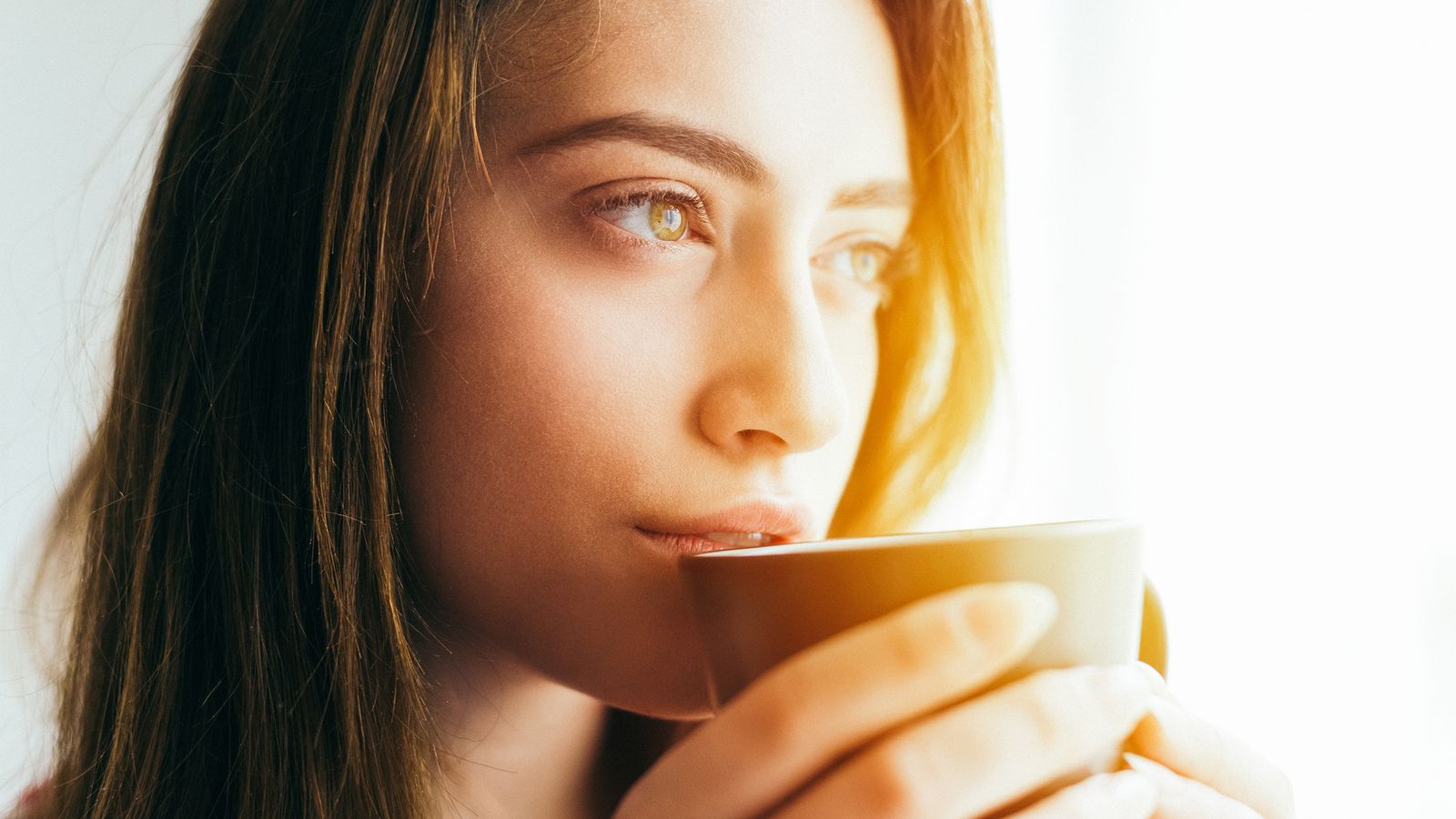 Frau, die ihren ersten Tee am Morgen trinkt