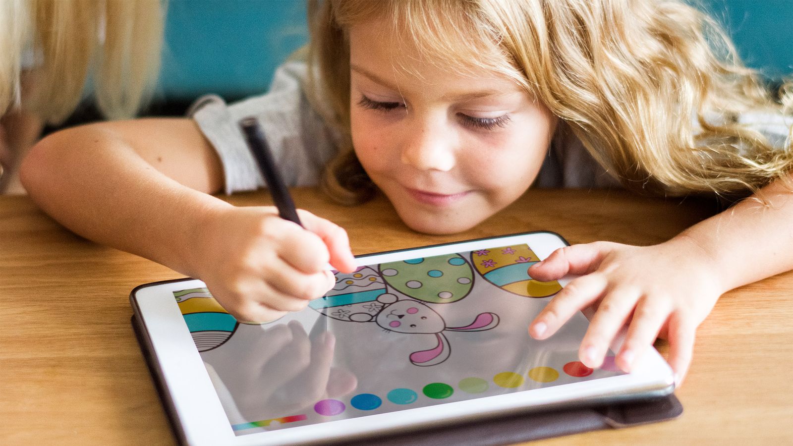 Kleines Kind ist am Tablet beschäftigt und hat darum Sprachprobleme