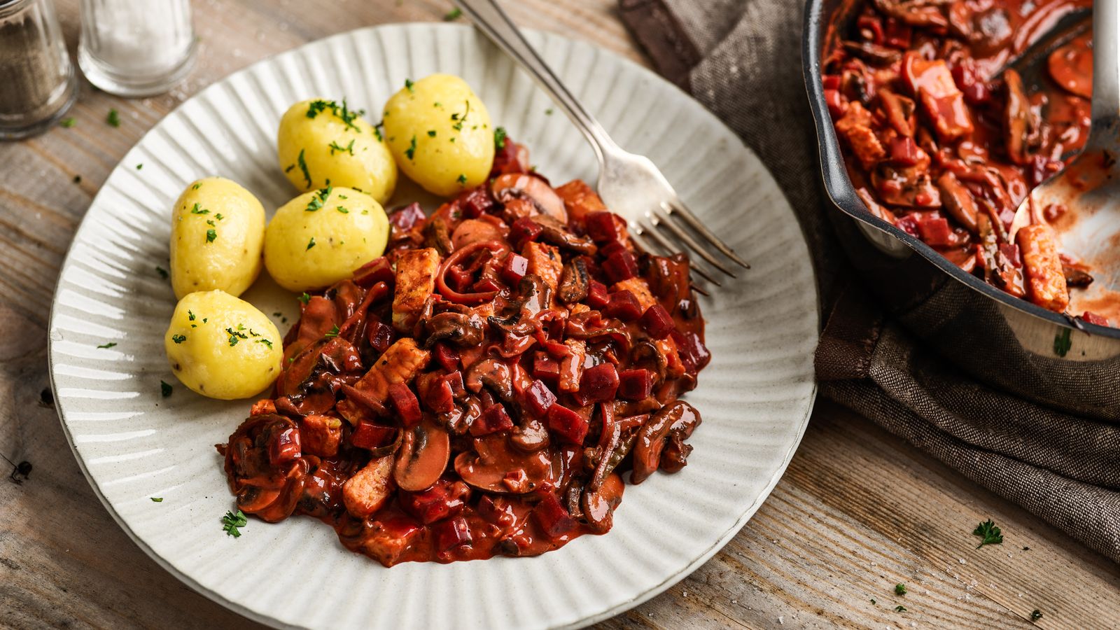  Tempeh-Stroganoff mit Salzkartoffeln auf einem weissen Teller serviert